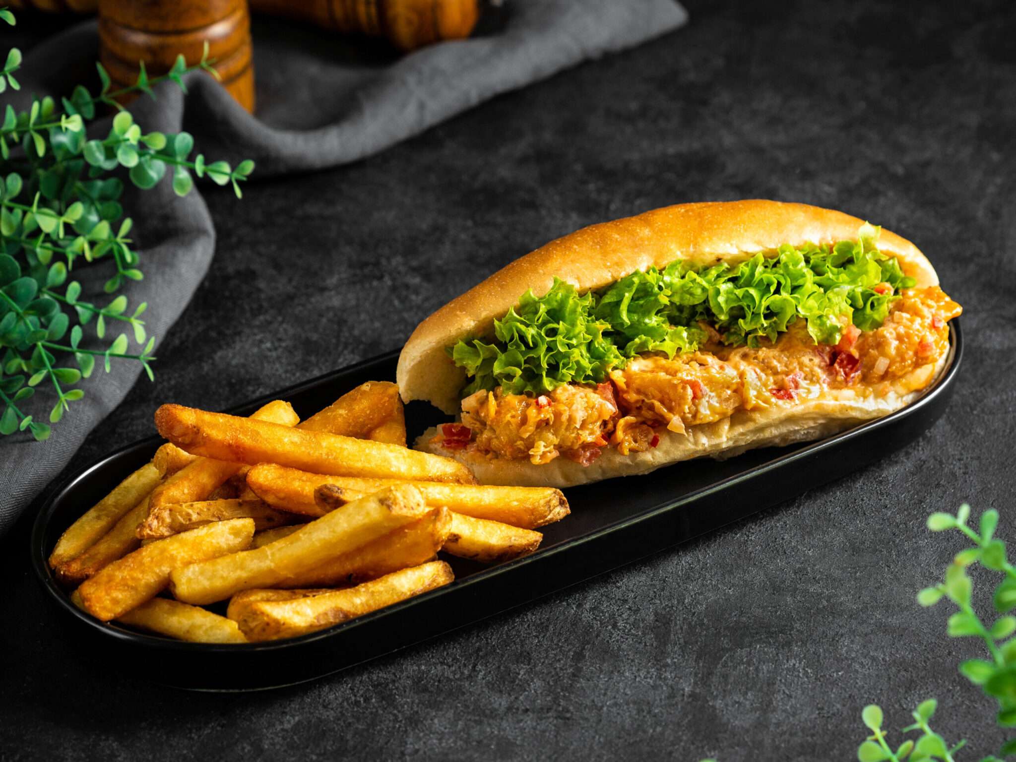 Dynamite Shrimp Sandwich.. Deep-fried shrimp, dynamite sauce, and lettuce served in french